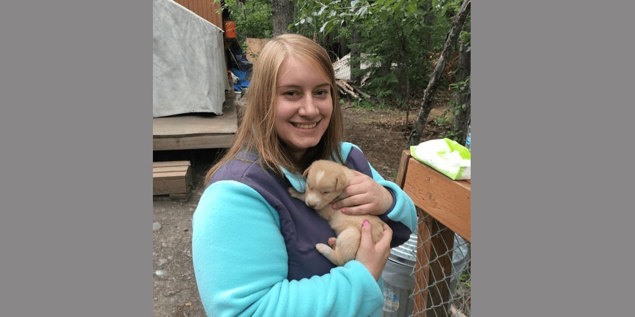 woman holding puppy